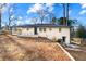 The backyard features a charming home with a patio, offering a perfect space for relaxation and gatherings at 932 Mount Airy Sw Dr, Atlanta, GA 30311