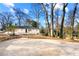 Charming home with a spacious backyard, a stone retaining wall and an area perfect for entertaining at 932 Mount Airy Sw Dr, Atlanta, GA 30311