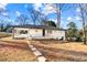 The backyard features a charming home with a patio, offering a perfect space for relaxation and gatherings at 932 Mount Airy Sw Dr, Atlanta, GA 30311