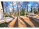Large, landscaped backyard featuring mature trees offers privacy and a park-like setting at 932 Mount Airy Sw Dr, Atlanta, GA 30311