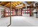 Unfinished basement with storage, painted floor, exposed ceiling, and red metal shelving at 932 Mount Airy Sw Dr, Atlanta, GA 30311