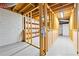 Partially finished basement with painted floor, exposed ceiling, exposed framing, and storage at 932 Mount Airy Sw Dr, Atlanta, GA 30311