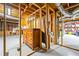 Partially finished basement with painted floor, exposed ceiling, exposed framing, and vintage cabinets at 932 Mount Airy Sw Dr, Atlanta, GA 30311