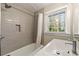 Updated bathroom boasts a sleek vanity, new fixtures, tile accents, and a shower/tub combo at 932 Mount Airy Sw Dr, Atlanta, GA 30311