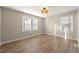 Bright bedroom featuring wood-look floors, neutral walls, and windows letting in natural light at 932 Mount Airy Sw Dr, Atlanta, GA 30311