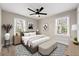 Staged bedroom showcasing natural light, ceiling fan, and coordinated decor at 932 Mount Airy Sw Dr, Atlanta, GA 30311