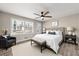 Cozy staged bedroom with natural light, a ceiling fan, and modern furniture at 932 Mount Airy Sw Dr, Atlanta, GA 30311
