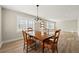 Bright dining room with a wooden table and chairs set, modern flooring, and ample natural light at 932 Mount Airy Sw Dr, Atlanta, GA 30311