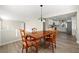 Open dining room and kitchen layout with wooden table and chairs, and modern gray flooring at 932 Mount Airy Sw Dr, Atlanta, GA 30311