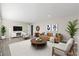 Bright, staged living room featuring hard wood floors, neutral paint and modern furniture at 932 Mount Airy Sw Dr, Atlanta, GA 30311