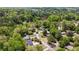 An aerial view of a neighborhood nestled amongst trees and a pond in the background at 2327 Doreen Ne Ct, Atlanta, GA 30345