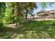 Spacious backyard with a view of the home's deck and surrounding trees at 2327 Doreen Ne Ct, Atlanta, GA 30345