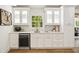 Stylish bar area with custom cabinets, wine fridge, quartz countertops, and modern fixtures at 2327 Doreen Ne Ct, Atlanta, GA 30345