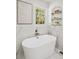 Elegant bathroom with a modern soaking tub, decorative shelving, and marble accents at 2327 Doreen Ne Ct, Atlanta, GA 30345