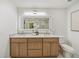 Bathroom featuring double vanity with wood cabinetry, illuminated mirror, and modern fixtures at 2327 Doreen Ne Ct, Atlanta, GA 30345