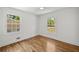 Bedroom featuring hardwood floors, white walls, and two windows offering a pleasant view at 2327 Doreen Ne Ct, Atlanta, GA 30345