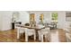 Dining room features hardwood floors, natural light, modern decor, and open floor plan to adjacent rooms at 2327 Doreen Ne Ct, Atlanta, GA 30345