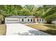 Charming renovated ranch-style home with white brick, black trim, new driveway and two car garage at 2327 Doreen Ne Ct, Atlanta, GA 30345