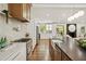 Modern kitchen featuring stainless steel appliances, custom cabinetry, island with sink, and hardwood flooring at 2327 Doreen Ne Ct, Atlanta, GA 30345