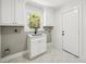 Laundry room featuring white cabinetry, marble floors, and a sink at 2327 Doreen Ne Ct, Atlanta, GA 30345