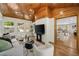 Bright living room with vaulted wood ceilings, white brick accents, modern decor, and view to dining room at 2327 Doreen Ne Ct, Atlanta, GA 30345