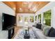 Inviting living room featuring wood vaulted ceilings, neutral furniture, large windows, and access to a deck at 2327 Doreen Ne Ct, Atlanta, GA 30345