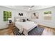 Serene main bedroom with natural light, ceiling fan, neutral decor, and hardwood floors at 2327 Doreen Ne Ct, Atlanta, GA 30345