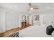 Bright main bedroom featuring hardwood floors, ceiling fan, closet with louvered doors, and neutral decor at 2327 Doreen Ne Ct, Atlanta, GA 30345