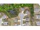 An aerial view of the homes located on a cul-de-sac with a water feature nearby at 5103 Woodline View Ln, Auburn, GA 30011