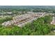An aerial view of the community showing numerous single Gathering homes surrounded by mature trees at 5103 Woodline View Ln, Auburn, GA 30011