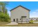 This image shows the home's backyard, including the building's gray exterior and a small patio at 5103 Woodline View Ln, Auburn, GA 30011