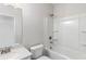 Clean bathroom with a shower-tub combo and a white marble vanity at 5103 Woodline View Ln, Auburn, GA 30011