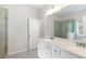 A primary bathroom boasts a double vanity, large mirror, and glass shower at 5103 Woodline View Ln, Auburn, GA 30011