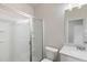 This bathroom offers a glass shower, vanity, and toilet at 5103 Woodline View Ln, Auburn, GA 30011