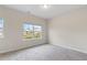 Bright, carpeted bedroom with natural light and a view of the outdoors at 5103 Woodline View Ln, Auburn, GA 30011