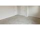 Spacious, carpeted bedroom featuring two doors, electrical outlets, and neutral decor at 5103 Woodline View Ln, Auburn, GA 30011