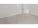 Neutral carpeted bedroom with white doors and view to another room at 5103 Woodline View Ln, Auburn, GA 30011