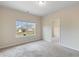 Bedroom featuring large window, neutral carpeting, and walk-in closet at 5103 Woodline View Ln, Auburn, GA 30011