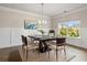 Elegant dining room featuring a modern table, chandelier, and large window at 5103 Woodline View Ln, Auburn, GA 30011