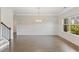 Bright dining room with hardwood floors and wainscoting, adjacent to the staircase and entry hall at 5103 Woodline View Ln, Auburn, GA 30011