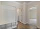 Entryway featuring a built-in storage bench, hardwood floors, and access to the bathroom at 5103 Woodline View Ln, Auburn, GA 30011