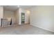 Hallway with neutral carpeting and stairs that can lead to another level of the home at 5103 Woodline View Ln, Auburn, GA 30011