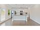Modern white kitchen with granite countertops, stainless steel appliances, and center island at 5103 Woodline View Ln, Auburn, GA 30011