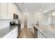 Kitchen featuring stainless steel appliances, granite countertops, a breakfast bar and hardwood floors at 5103 Woodline View Ln, Auburn, GA 30011