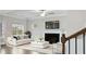 Bright living room with a fireplace, white sofa, and a view to the outside at 5103 Woodline View Ln, Auburn, GA 30011