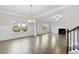 Bright living room with hardwood floors, fireplace, and large windows offering ample natural light at 5103 Woodline View Ln, Auburn, GA 30011
