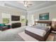 Spacious primary bedroom with tray ceilings and modern furniture at 5103 Woodline View Ln, Auburn, GA 30011