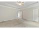 Large main bedroom features a tray ceiling and neutral carpeting at 5103 Woodline View Ln, Auburn, GA 30011