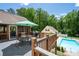 The backyard features an elevated deck with outdoor furniture overlooking the in-ground pool at 96 Grover Way, Dallas, GA 30157