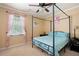 This bedroom features a four poster bed, a ceiling fan, and natural light from the window at 96 Grover Way, Dallas, GA 30157